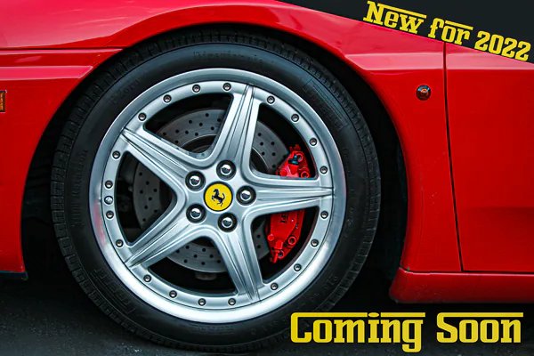 The wheel of a Ferrari sports car.   Motorsport photography by Jeffrey Meyer.